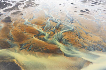 Abstract aerial view of a river basin in Iceland, with intricate patterns of sediment - ADSF51091