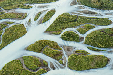 An aerial shot captures the winding rivers and lush green terrain of Iceland's picturesque river basins, highlighting the country's natural beauty - ADSF51097