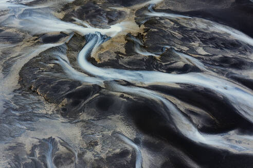 This image captures the winding patterns of Iceland's river basins, showcasing a mesmerizing natural tapestry from an aerial perspective - ADSF51099