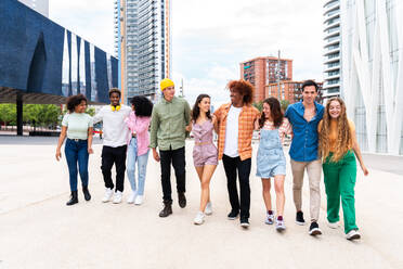 Happy playful multiethnic group of young friends bonding outdoors - Multiracial millennials students meeting in the city, concepts of youth, people lifestyle, diversity, teenage and urban life - DMDF08970