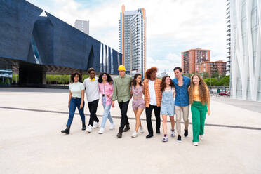 Happy playful multiethnic group of young friends bonding outdoors - Multiracial millennials students meeting in the city, concepts of youth, people lifestyle, diversity, teenage and urban life - DMDF08971