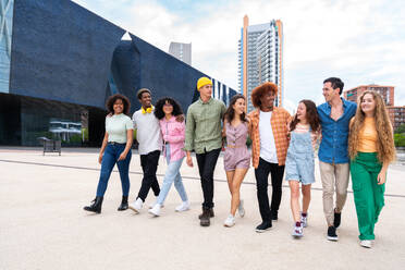 Happy playful multiethnic group of young friends bonding outdoors - Multiracial millennials students meeting in the city, concepts of youth, people lifestyle, diversity, teenage and urban life - DMDF08972