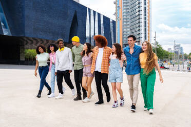 Happy playful multiethnic group of young friends bonding outdoors - Multiracial millennials students meeting in the city, concepts of youth, people lifestyle, diversity, teenage and urban life - DMDF08974