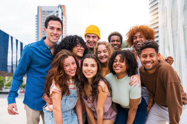 Happy playful multiethnic group of young friends bonding outdoors - Multiracial millennials students meeting in the city, concepts of youth, people lifestyle, diversity, teenage and urban life - DMDF08983