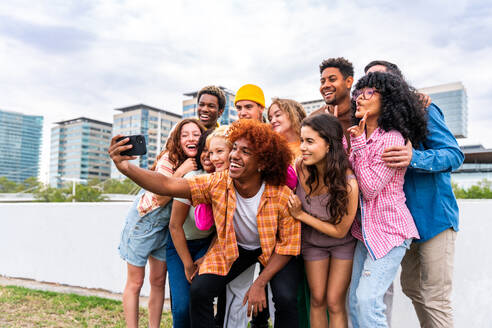 Happy playful multiethnic group of young friends bonding outdoors - Multiracial millennials students meeting in the city, concepts of youth, people lifestyle, diversity, teenage and urban life - DMDF09151