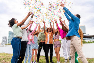 Happy playful multiethnic group of young friends bonding outdoors - Multiracial millennials students meeting in the city, concepts of youth, people lifestyle, diversity, teenage and urban life - DMDF09156