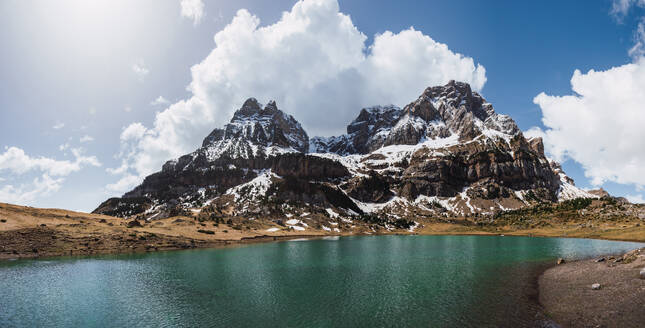 Scenic panoramic vista of snow-capped peaks reflected in a tranquil mountain lake at Ordesa National Park in the Pyrenees - ADSF51234