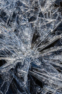 A close-up of complex ice crystals forming an abstract design against a contrasting dark background. - ADSF51536