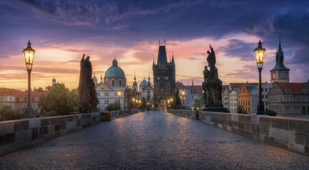 Serene twilight over Charles Bridge, featuring iconic Prague landmarks under a vibrant sunset sky. - ADSF51590