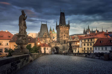 Early morning view of the historic Charles Bridge against a dramatic sky in Prague, Czech Republic, with beautiful baroque statues. - ADSF51591