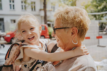 Happy girl enjoying with grandmother on sunny day - MASF41548