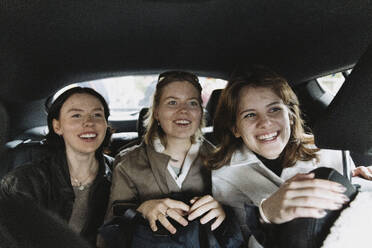 Excited female friends traveling in car on vacation - MASF41893