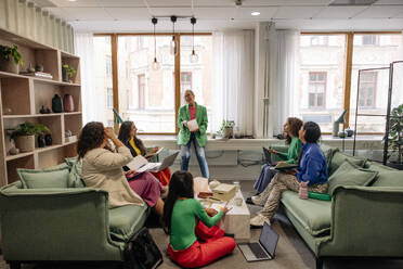 Happy female entrepreneurs enjoying during business meeting at office - MASF41921