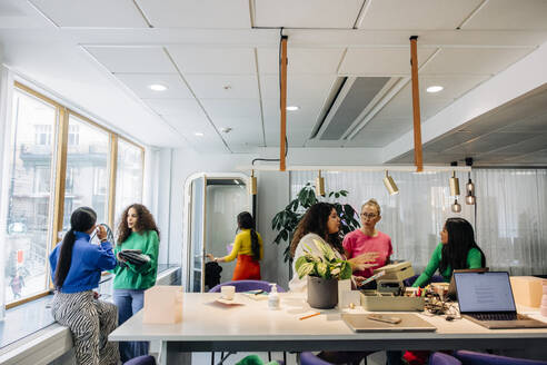 Multiracial female colleagues working together at modern office - MASF41959