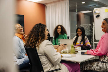 Happy business female professionals discussing in meeting at office - MASF41988