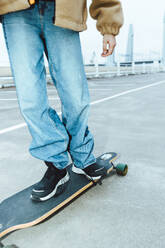 Low section of girl skateboarding on street during weekend - MASF42185