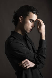 Stressed young man wearing black shirt - LMCF00750