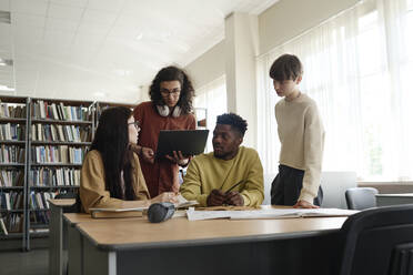 Students having discussion together in library - DSHF01512