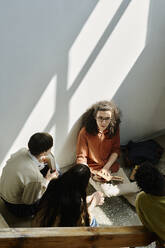 Students sitting and having discussion on floor at university - DSHF01521