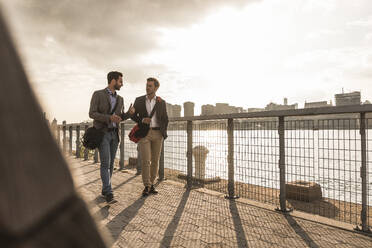 Business colleagues walking by Hudson River in New York City, USA - UUF30957