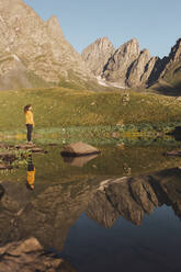 Woman standing near Abudelauri lake in front of Caucasus mountains - PCLF00945