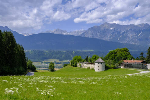 Austria, Tyrol, Kolsassberg, Green summer meadow in front of Rettenberg castle - LBF03866