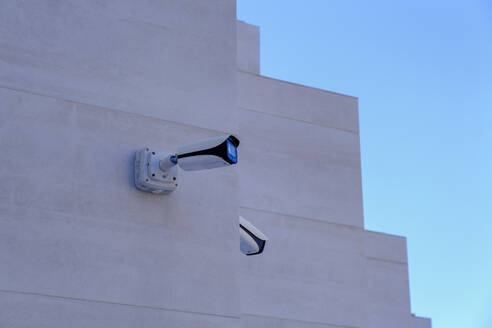 Spain, Balearic Islands, Cala Sant Vicenc, Security cameras on hotel facade - LBF03875