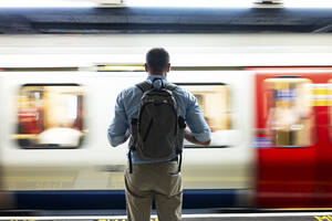 Mature businessman standing on subway platform - WPEF08070