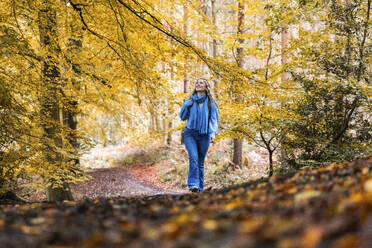 Smiling woman walking in Cannock chase forest - WPEF08082