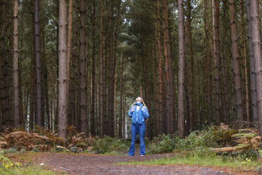 Frau steht in der Nähe von Bäumen im Cannock Chase Forest - WPEF08096