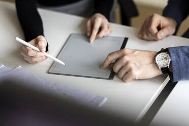 Hände von Kollegen mit Tablet-PC auf dem Schreibtisch im Büro - PESF04194