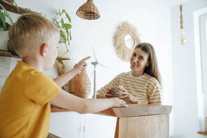 Mother and son at home with wind turbine model - WESTF25303