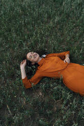 Smiling woman relaxing in corn field - TOF00232