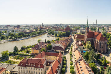 Poland, Lower Silesian Voivodeship, Wroclaw, Aerial view of Oder river and surrounding old town buildings in summer - TAMF04098