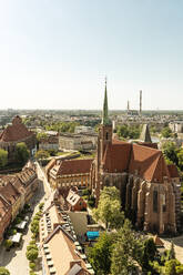 Poland, Lower Silesian Voivodeship, Wroclaw, Aerial view of Collegiate Church of Holy Cross and St. Bartholomew in summer - TAMF04099