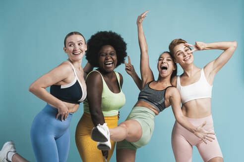 Cheerful multiracial women against blue background - OIPF03763