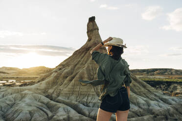 Tourist standing near Castildetierra at sunset - DAMF01237