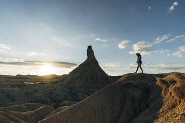 Tourist standing near Castildetierra under sky at sunset - DAMF01239