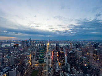 Scenic Luftaufnahme von Manhattan in New York City mit Hochhäusern in der Nähe des Flusses unter bewölktem Himmel mit heller Sonne bei Sonnenuntergang befindet - ADSF52068