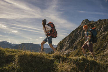 Couple walking on mountain trail in Tannheimer Tal, Tyrol, Austria - UUF30985