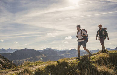 Junges Paar beim Wandern auf einem Bergpfad im Tannheimer Tal, Tirol, Österreich - UUF30986