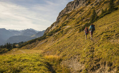 Man and woman hiking in Tannheimer Tal, Tyrol, Austria - UUF30999