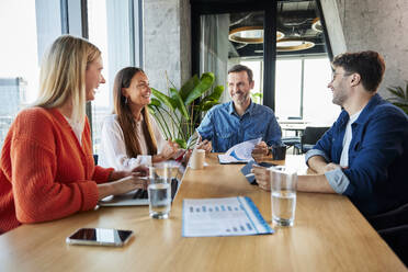 Happy business colleagues having meeting in conference room - BSZF02389