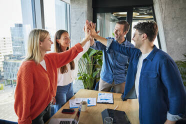 Happy business colleagues give high-five in office - BSZF02391