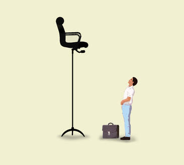 Ambitious businessman looking up at tall chair over yellow background - GWAF00459