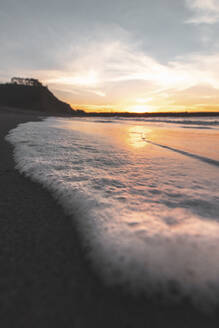 Beach waves on coastline in Asturias, Spain at sunset - MMPF01149