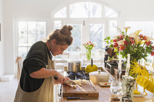 Teenage girl (16-17) preparing meal in kitchen - TETF02430