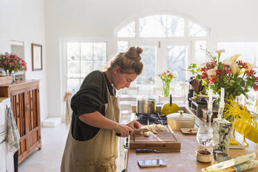 Teenage girl (16-17) preparing meal in kitchen - TETF02432