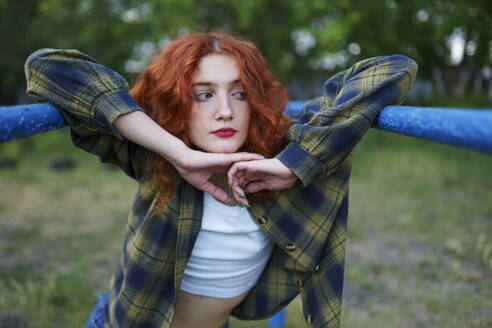 Redhaired woman posing at playground - TETF02449