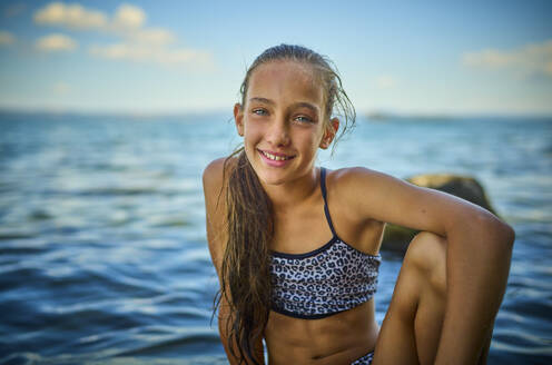 Girl sitting near lake Bolsena, Italy - DIKF00812